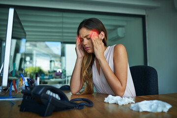 Poster - I cant work like this. Shot of a young businesswoman suffering with a headache while working in an office.