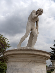 Poster - Beautiful view of a human sculpture under the cloudy sky in Paris