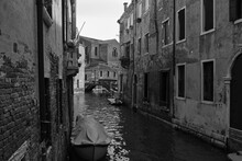 Old Narrow Canals With Gondolas In Venice, Italy