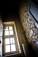 Wall Mural - Vertical shot of an old abandoned house room interior