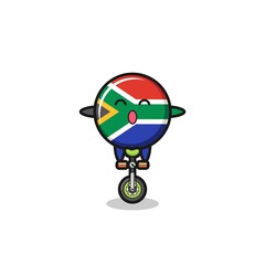 Poster - The cute south africa flag character is riding a circus bike