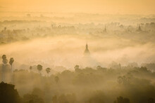 Elevated View Of The Plain Of Temples In Mandalay, Stupas And Spires Emerging From The Mist, Historic Buddhist Sites.