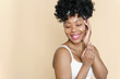 © etonastenka - Skin care. Beauty portrait of a black woman looking away on a beige background. Copy Space.