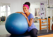 Woman Exercising With Ball In Gym
