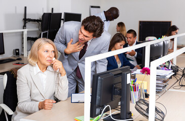 Wall Mural - Outraged manager expressing dissatisfaction with work of frustrated unhappy mature woman in coworking space