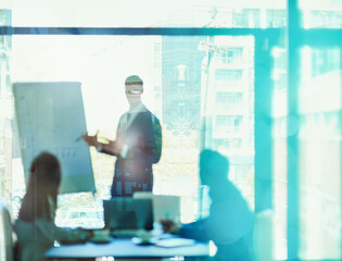 Poster - The future of success starts here. Shot of a young executive giving a presentation to colleagues in a boardoom.
