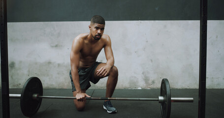 Poster - When faced with a challenge, dont run for the exit. Portrait of a muscular young man exercising with a barbell in a gym.