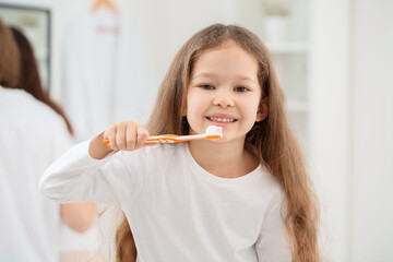 Sticker - Adorable little girl brushing teeth in bathroom, closeup