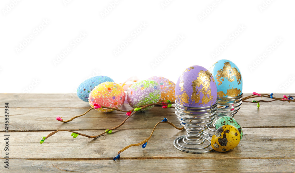 Painted Easter eggs on table against white background