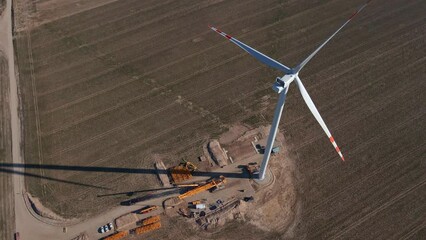 Canvas Print - Installing new wind generator, Windmill turbine maintenance, Construction site with cranes for assembling windmill tower, Wind power and renewable energy