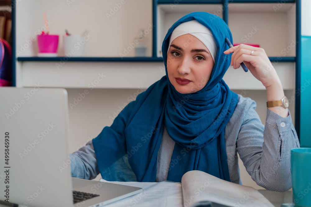 Muslim student in hijab learning at home desk. Confident Muslim ...