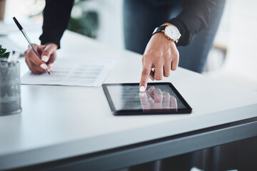 Poster - Striking a connection with success. Closeup shot of an unrecognisable businesswoman writing notes while using a digital tablet in an office.