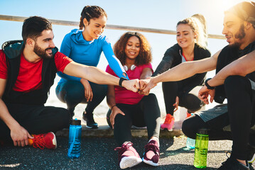 Poster - That was a good start. Shot of a group of young cheerful friends forming a huddle after a fitness exercise outside during the day.