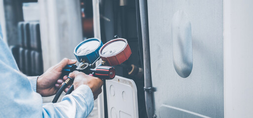 air repair mechanic using measuring equipment for filling indust