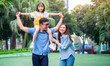 © Timeimage - Image of young Asian family playing together at park