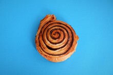 Traditional Popular Hungarian Sweet Pastry Called Cocoa Snail Named "kakaos Csiga"  On A Light Blue Background