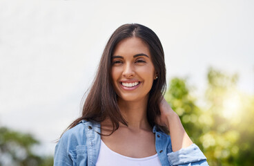 Poster - Beauty is happiness in the heart. Cropped shot of an attractive young woman standing outdoors.