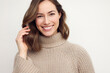 © Martin Villadsen - Portrait of a happy smiling brunette woman looking beautiful standing isolated on white background in a sweater. Young female girl with a perfect smile.