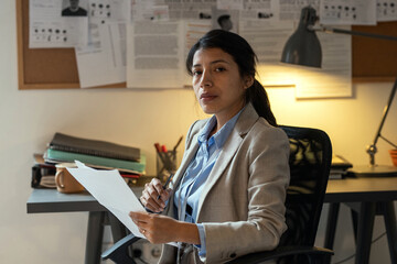 Aufkleber - Young confident female agent of FBI in formalwear learning personal information of suspects while looking through criminal profiles