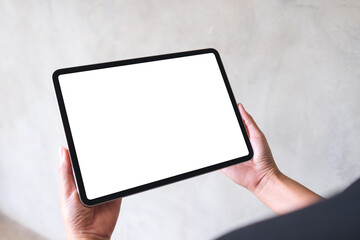 Mockup image of a woman holding digital tablet with blank white desktop screen