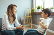 © Dragana Gordic - Young boy having therapy with a child psychologist. Shot of a young child psychologist talking with a boy. Friendly young child psychologist talking with little boy suffering from emotional disorder