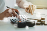 Fototapeta  - women using calculator calculated individual income tax for pay taxes annual.Financial research,government taxes and calculation tax return concept. Tax and Vat concept.