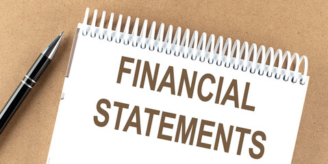 Poster - FINANCIAL STATEMENTS text on a notepad with pen, business