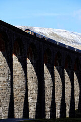 Wall Mural - Train passing over ribblehead viaduct, yorkshire dales, in winter