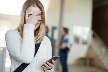 Poster - This is so embarrassing. Cropped shot of a university student covering her face.