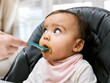 © Kay A/peopleimages.com - This tastes a little different than what Im used to. Shot of a mother feeding her adorable baby girl.