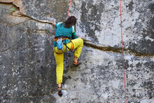 Girl Climber Trains On A Sheer Cliff
