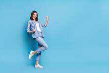 Photo Of Lucky Adorable Lady Dressed Denim Shirt Empty Space Rising Fists Isolated Blue Color Background