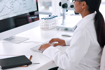 Poster - Shes a genius behind the computer. Cropped shot of an unrecognizable young female scientist working on her computer in the laboratory.