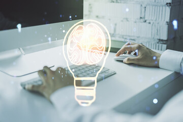 Poster - Creative light bulb illustration with human brain and with hands typing on computer keyboard on background, future technology concept. Multiexposure