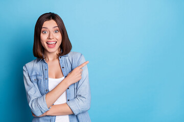 Wall Mural - Photo of excited astonished person direct finger empty space offer proposition isolated on blue color background