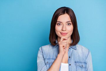 Poster - Portrait of satisfied minded person arm on chin look camera imagine isolated on blue color background