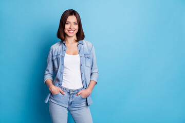Wall Mural - Photo of charming shiny woman wear jeans shirt smiling empty space isolated blue color background
