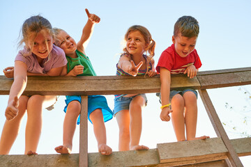 Wall Mural - These are their happiest days. Portrait of a group of little children showing thumbs up while playing together outdoors.