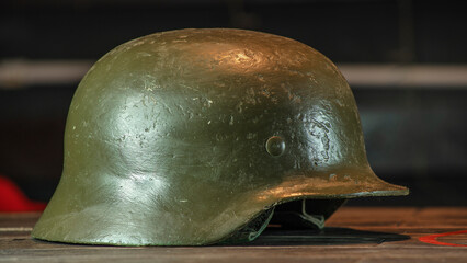 Close-up view of green metal military helmet on black background. Russian camo helmet. War concepts.