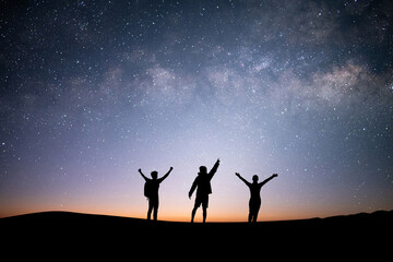 silhouette group of young traveler and backpacker watched the star and milky way on top of the mount