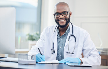Poster - How can I make you feel better. Shot of a handsome young doctor sitting alone in his clinic and making notes.