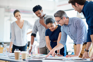 Aufkleber - Theyve got planning down to a fine art. Mature man describing a plan of action to his diverse creative team.