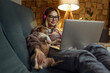 © руслан малыш - A girl with a dog watching a movie on a laptop with headphones. Pets and pet friends for people