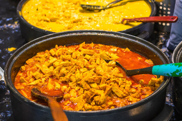 Wall Mural - Chicken curry on display at Brick Lane Market in London