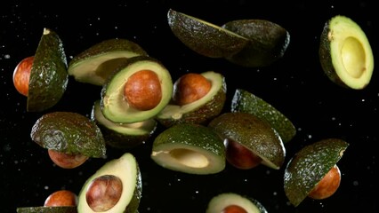 Poster - Super slow motion of fresh avocados flying in the air on black background. Filmed on high speed cinema camera, 1000 fps.