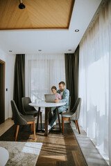 Wall Mural - Father and daughter using laptop computer together