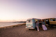 © simona - Group of friends celebrate toasting in summer travel holiday vacation. Camper van lifestyle. people man and women together having fun in outdoor leisure activity. Ocean view in free camp site