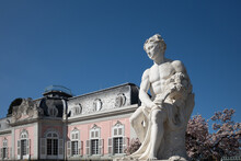 Selective Focus At White Classical Male Human Sculpture And Background Of Schloss Benrath, Old Classic Residence Palace.