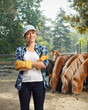 Female stud farm worker posing with horses