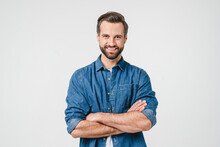 Confident Caucasian Young Man In Casual Denim Clothes With Arms Crossed Looking At Camera With Toothy Smile Isolated In White Background